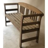 GARDEN SEAT, weathered teak, slatted with arched carved rose centred back and scroll arms, 130cm W.