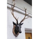 FAUX TROPHY HEAD, mounted on shield, 100cm x 60cm x 60cm.