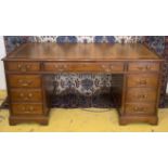 PEDESTAL DESK, George III style mahogany with brown leather top above eight drawers,