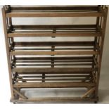 SHOE RACK, vintage, early 20th century pine with five slatted shelves and castors,