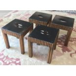 SIDE TABLES, a set of four, with black lacquered tops on reeded giltwood bases,