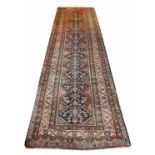 ANTIQUE FEREGHAN RUNNER, 400cm x 112cm, diamond herati field within corresponding borders.