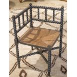 WILLIAM MORRIS STYLE CORNER CHAIR, 19th century ebonised with bobbin frame and rush seat.