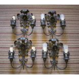 WALL LIGHTS, a set of four, black metal with rise back plates and twin branches, 39cm H x 34cm.