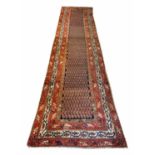ANTIQUE MALAYER RUNNER, 395cm x 100cm, repeat boteh field within corresponding bands and borders.