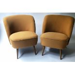 COCKTAIL CHAIRS, a pair, 1960's style orange cotton on swept supports, 66cm W.