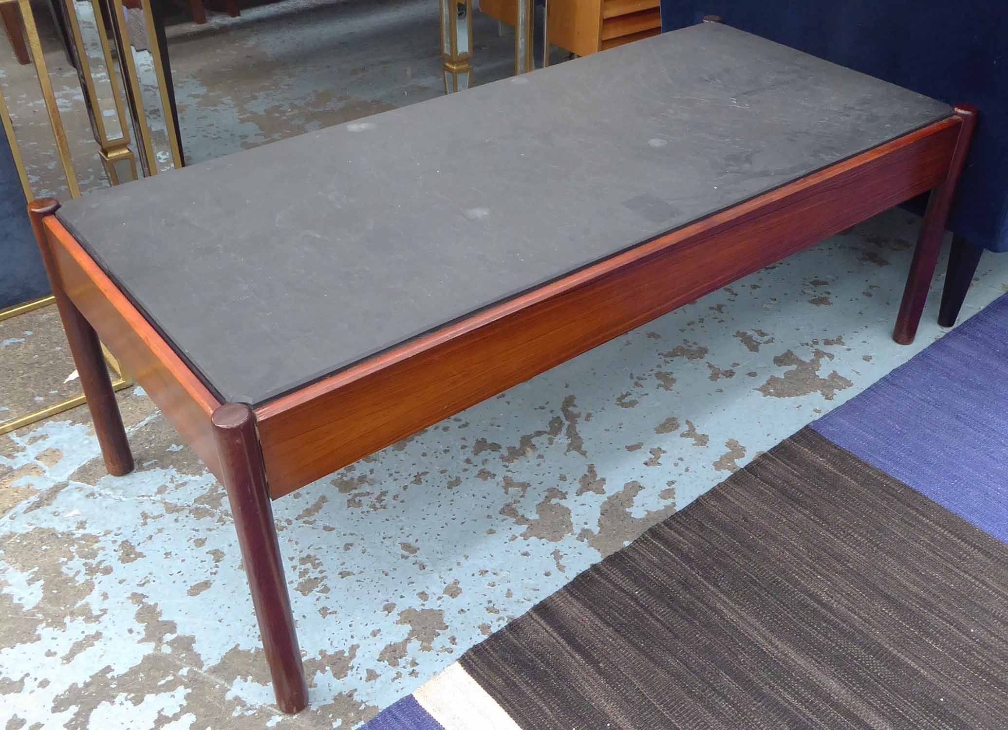 LOW TABLE, mid 20th century Danish rosewood with an inset slate top, 129cm W x 59cm D x 47cm H.