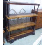 INDUSTRIAL STYLE SHELVES, with four wooden tiers on wheels, 122cm W x 137cm H x 42cm D.