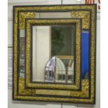 WALL MIRROR, 19th century Flemish, ebonised and repoussé brass with rectangular cushion frame,