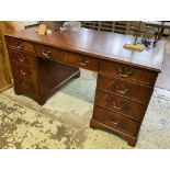PEDESTAL DESK, Georgian style mahogany with red leather top above eight drawers,