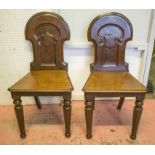 HALL CHAIRS, a pair, Victorian mahogany with arched and cartouche panelled backs.