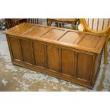 COFFER, Jacobean style oak with hinged panelled top, 54cm H x 127cm W x 45cm D.