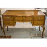 DESK, Queen Anne style burr walnut with shaped top above five drawers, 80cm H x 128cm W x 52cm D.