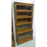 GLOBE WERNICKE BOOKCASE, early 20th century five tier oak with rising glazed fronted compartments,