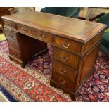 PEDESTAL DESK, Georgian style mahogany with green leather top above nine drawers,