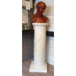 BUST OF A MAIDEN, simulated terracotta, 53cm H x 43cm W, with a painted pedestal, 122cm H x 45cm W.