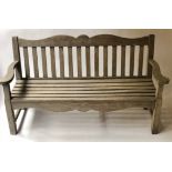 GARDEN BENCH, silvery weathered teak with shaped back and broad scroll shaped arms, 160cm W.