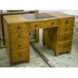 MAPLE & CO DESK, circa 1930, oak with partial brown leather top above nine drawers,