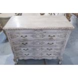 COMMODE, in a distressed painted finish with carved detail and four long drawers,