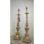 TABLE LAMPS, a pair, carved wood in a distressed gilt finish, bases each 62cm H.