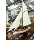 MODEL YATCH, with substantial sails, on ebonised stand.