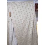 CURTAINS, a pair, cream with Fleur De Lys pattern, each curtain 143cm W gathered x 250cm Drop.