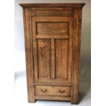 ARTS AND CRAFTS WARDROBE, oak with panelled door enclosing hanging space above a full width drawer,