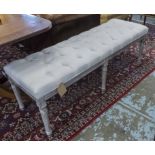 FOOTSTOOL, with a buttoned cream upholstered top on six distressed fluted supports,