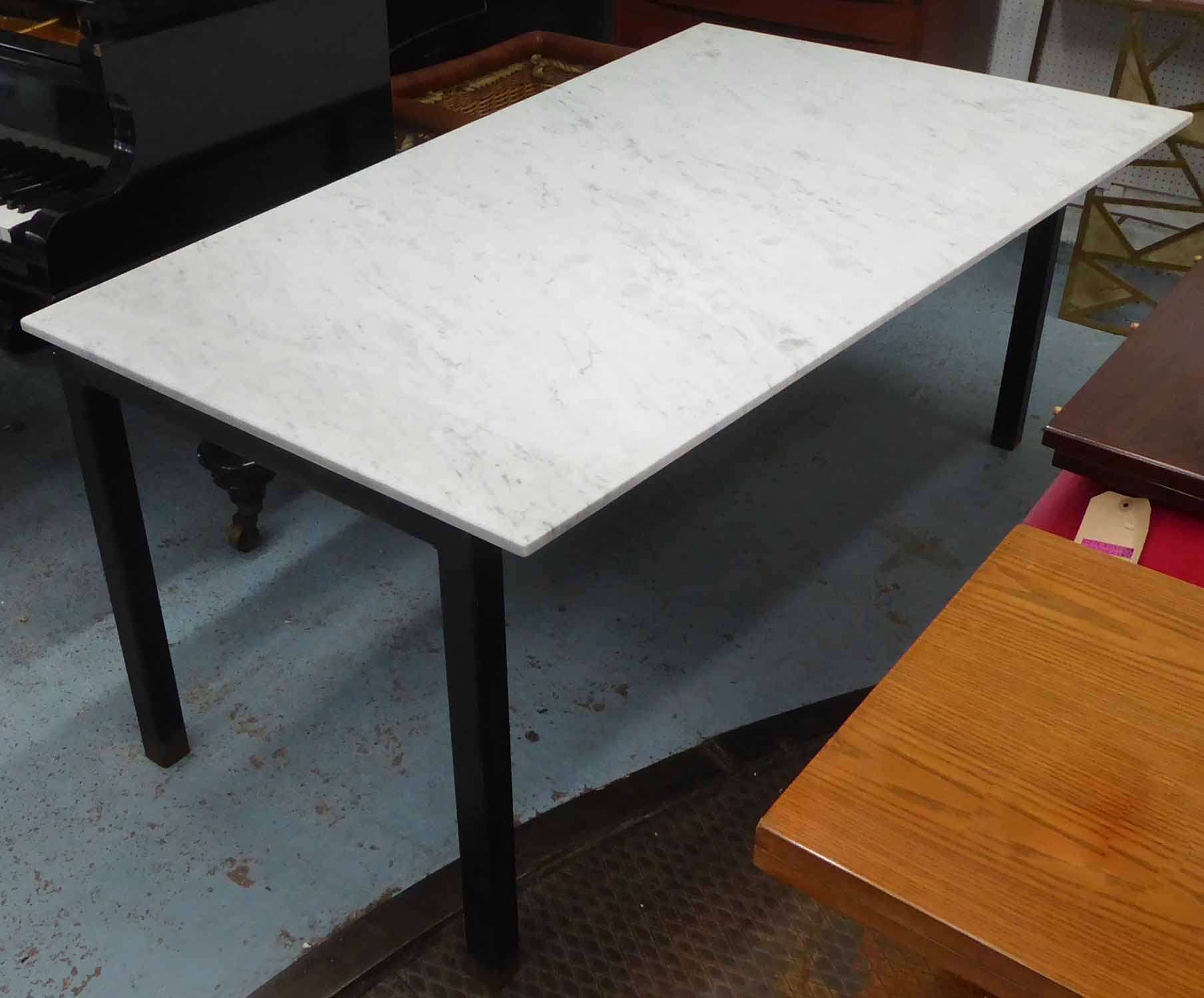 TABLE, with an asymmetric white marble top on a metal base, 171cm L x 100cm D x 74cm H.