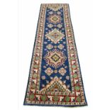 KAZAK RUNNER, 260cm x 80cm, row of geometric medallions within corresponding borders.