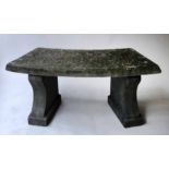 GARDEN BENCH, well weathered reconstituted stone curved with shaped block supports,
