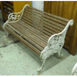 GARDEN BENCH, late Victorian with a slatted wooden back and seat and white painted cast iron ends,