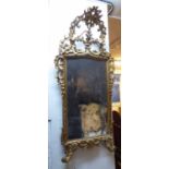 WALL MIRROR, 18th century Italian giltwood with an elaborate surmount,