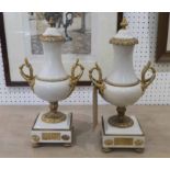 LIDDED URNS, a pair, white marble with gilt metal detail, each 37cm H x 12cm W.