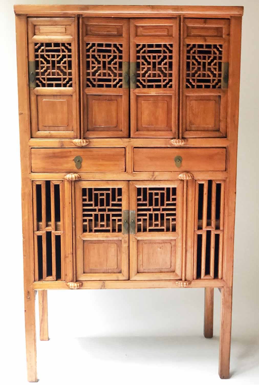 CHINESE CABINET, early 20th century pierced firwood with six doors shelves and stile supports,