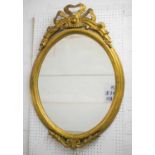 OVAL WALL MIRROR, gilt wood with tied ribbon crest, 95cm H x 63cm.