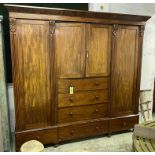 BEACONSFIELD WARDROBE, William IV mahogany of four doors enclosing hanging rails above six drawers,