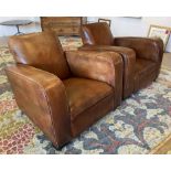 CLUB ARMCHAIRS, a pair, Art Deco design tan leather on block feet and castors,