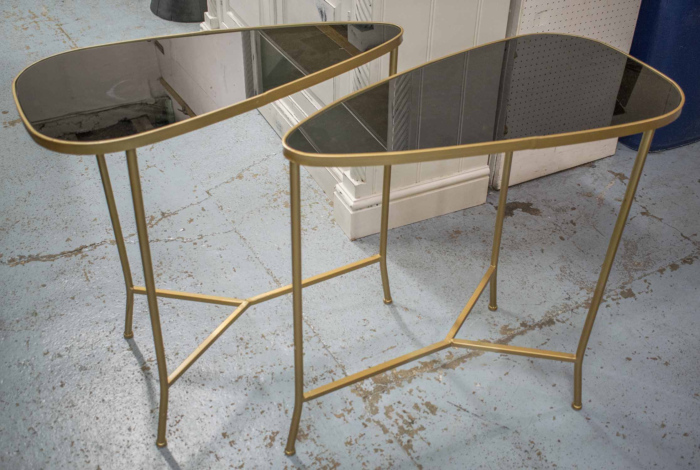 SIDE TABLES, a pair, 1970's Italian style gilt metal with ovoid shaped black lacquer tops,