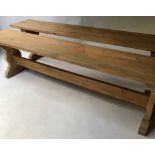 REFECTORY BENCHES, a pair, pine each with trestle stretchered supports, 207cm x 35cm x 47cm H.
