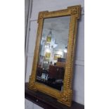 WALL MIRROR, Georgian style with a rosette eared shaped giltwood frame, 60cm x 102cm.