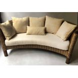 WICKER SOFA, woven wicker of bowed form with turned supports, seat and scatter cushions, 178cm W.