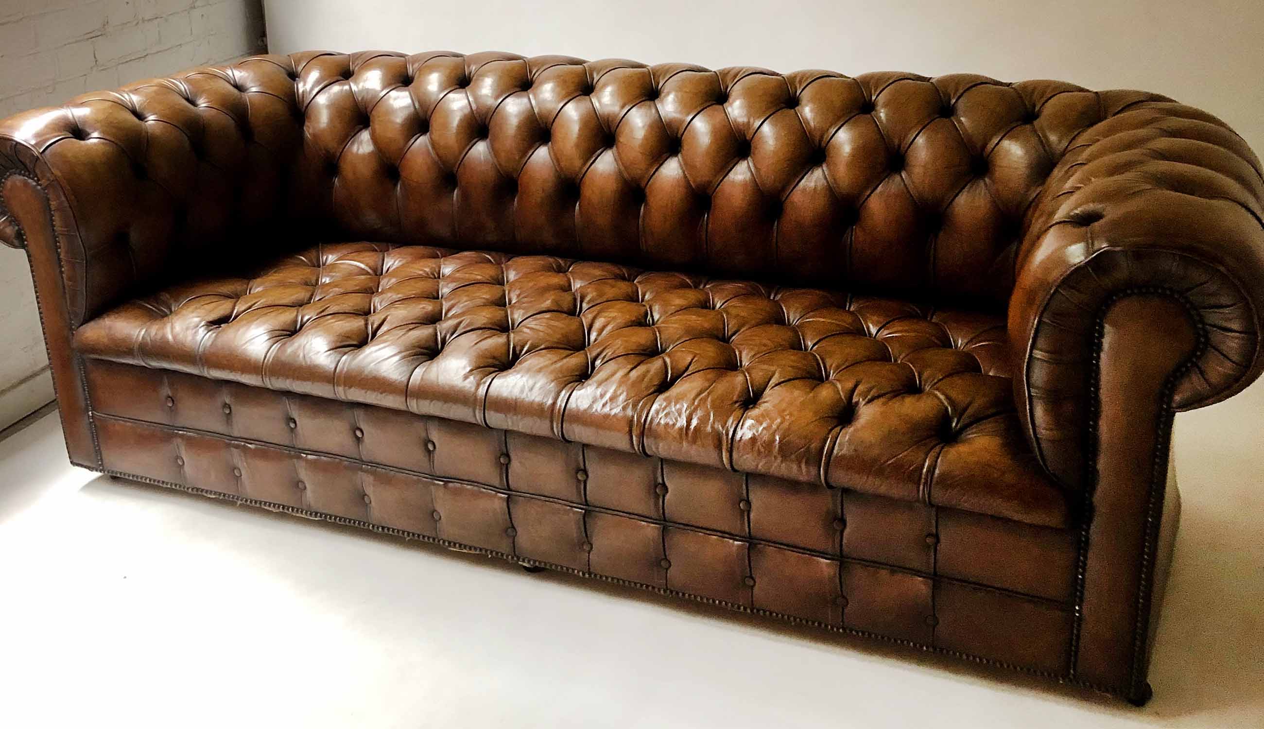 CHESTERFIELD SOFA, early 20th century buttoned tan leather, 210cm W.