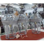 HALL LANTERNS, three in a painted grey metal finish and curved glass, each 67cm H x 31cm W.