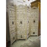 SCREEN, Indian white painted of four foliate carved panels with metal mounts,