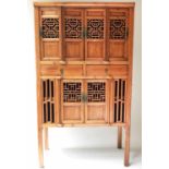 CHINESE CABINET, early 20th century pierced firwood with six doors shelves and stile supports,