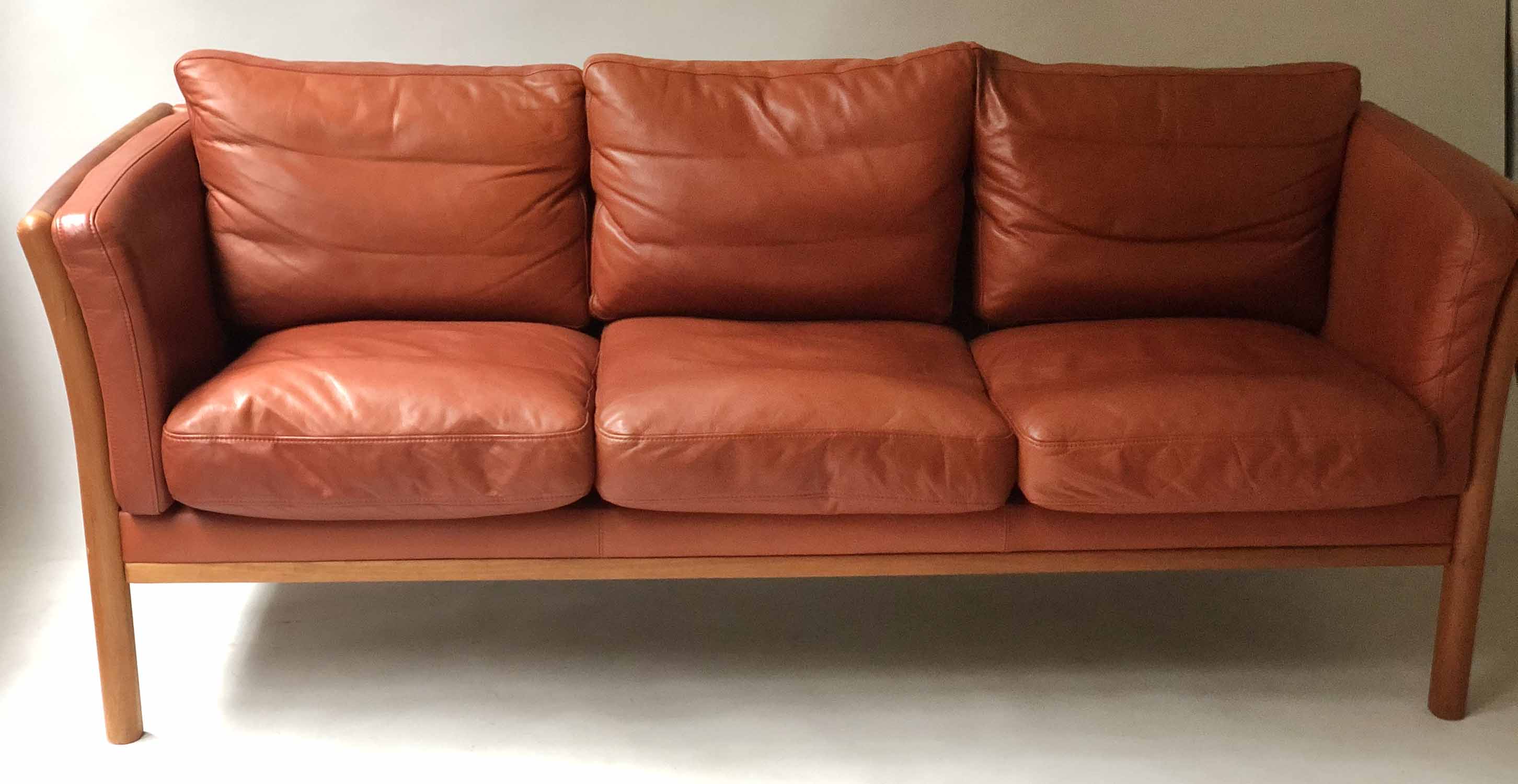 SOFA, mid 20th century Danish in hand finished grained mid brown leather with three seat cushions,