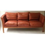 SOFA, mid 20th century Danish in hand finished grained mid brown leather with three seat cushions,