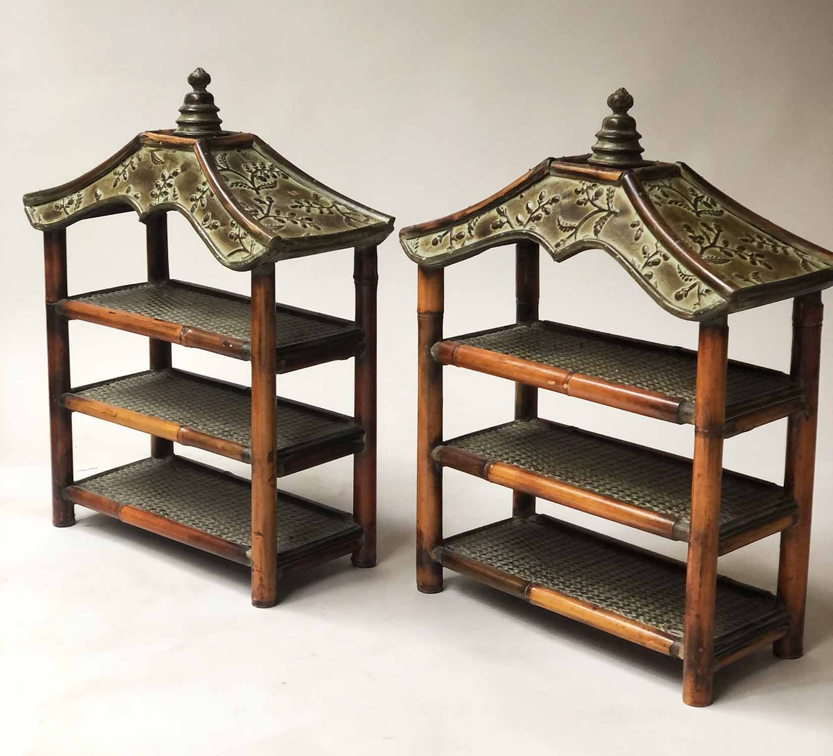 HANGING SHELVES, a pair, bamboo and cane shelved each with verdigris pagoda tops, 59cm H x 44cm W.