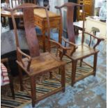 OPEN ARMCHAIRS, a pair, 19th century Chinese elm, each with a panelled seat, 59cm W x 124cm H.